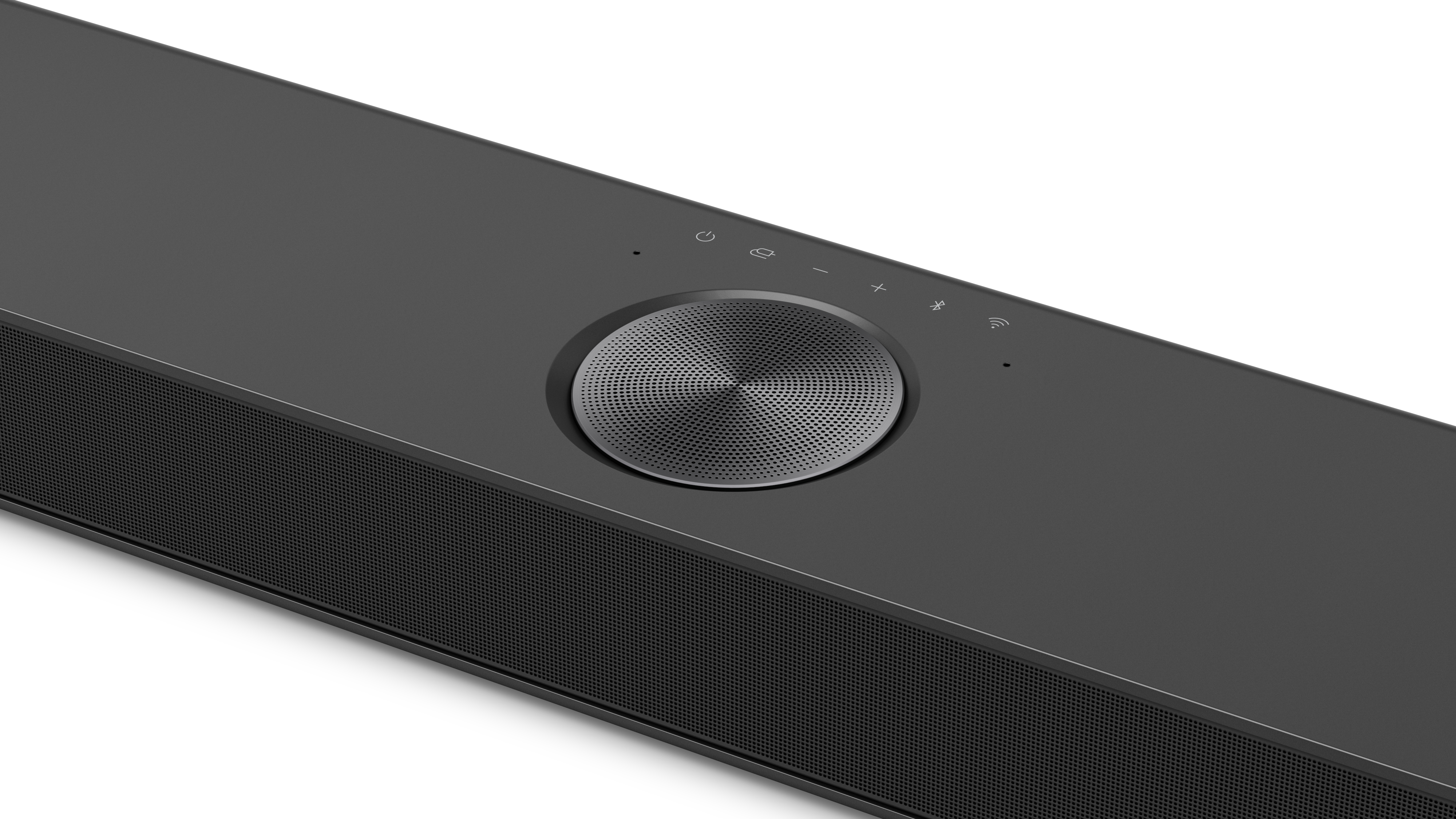 Eine schwarze Soundbar mit einem zentralen kreisförmigen Lautsprecher, Ein-/Aus- und Lautstärketasten, weißer Hintergrund.