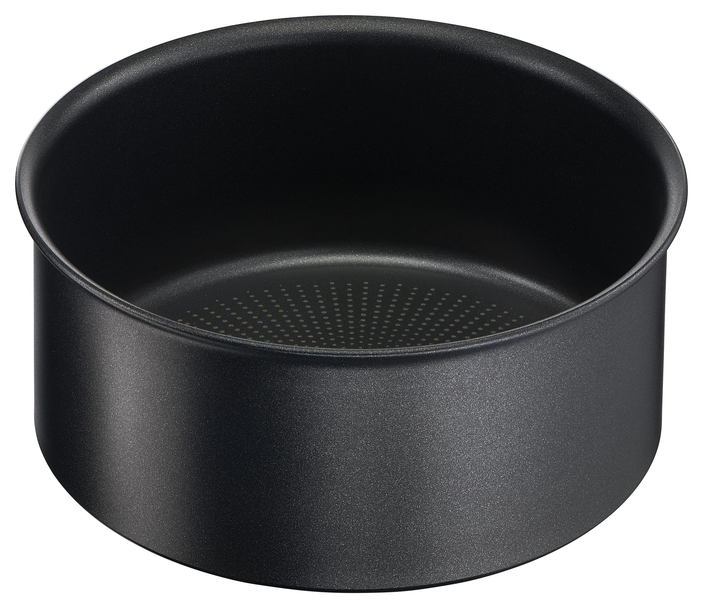 Czarna patelnia. Ma okrągły kształt z lekko zakrzywioną krawędzią.