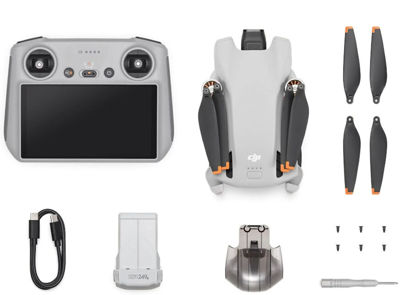 Zestaw drona z kontrolerem, baterią, ładowarką i zapasowymi śmigłami.