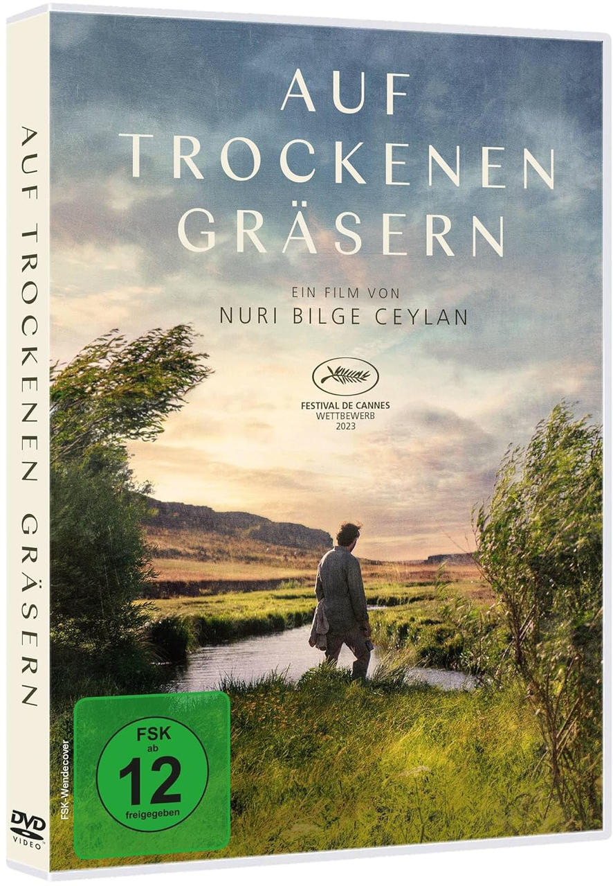 DVD-Hülle des Films 'Auf Trockenen Gräsern'. Sie zeigt eine Person in der Natur.