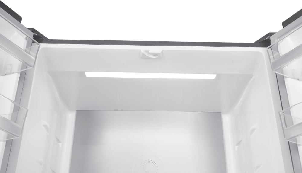 Inside of a white refrigerator. A light is present.