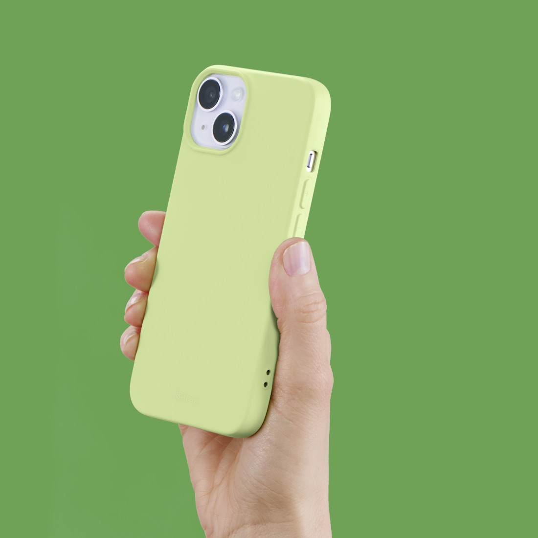 Hand hält ein hellgrünes Telefon vor grünem Hintergrund.