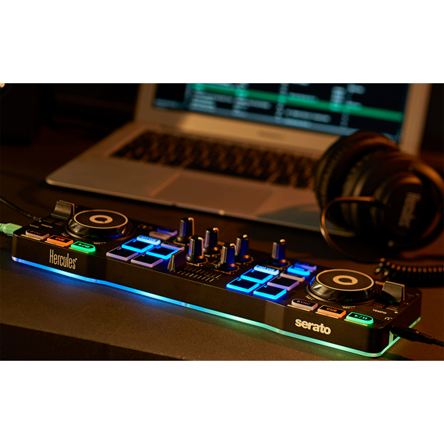 Controller DJ su una scrivania. Laptop e cuffie sullo sfondo.