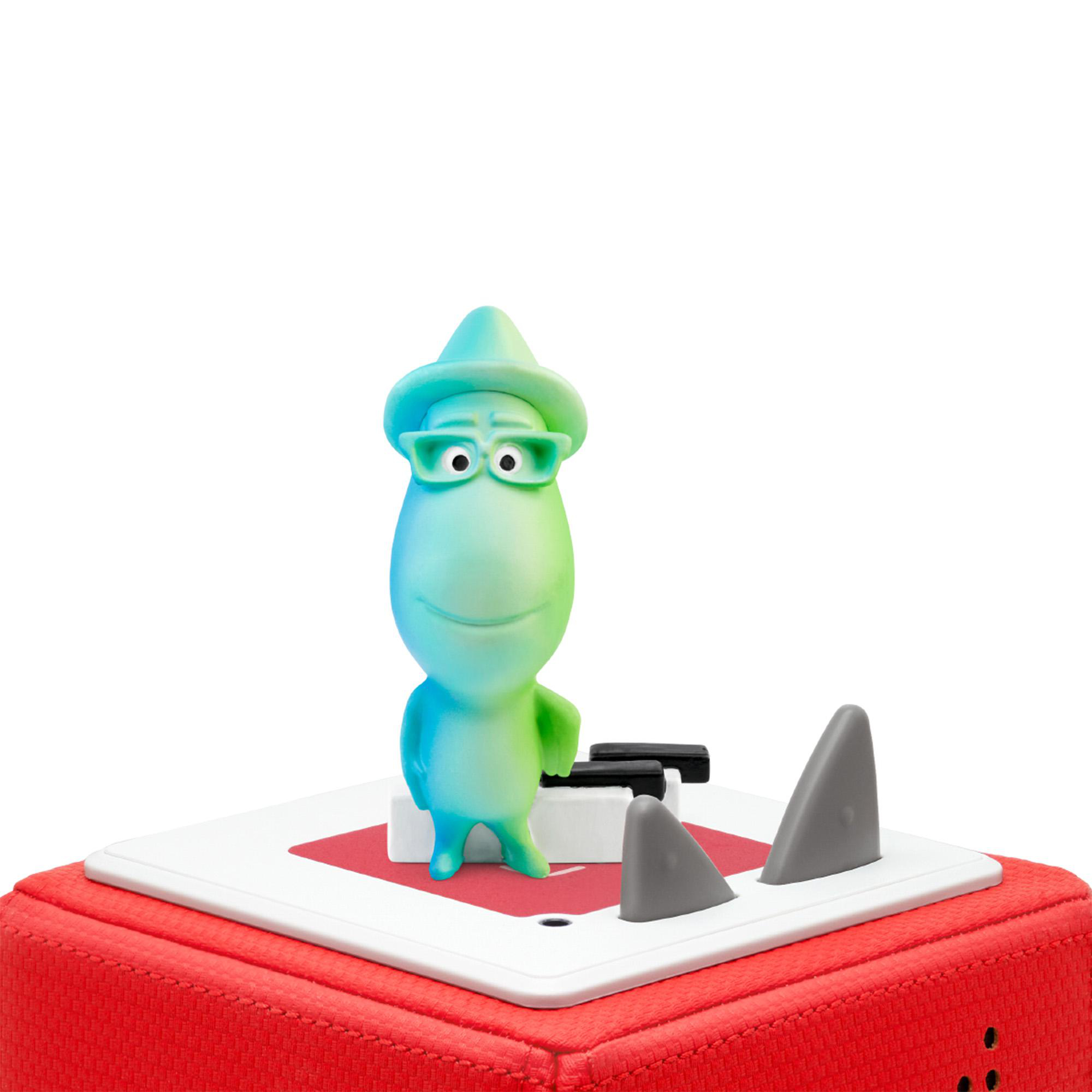 Eine grün-blaue Cartoonfigur mit Brille steht auf einem roten Quadrat. Haifischflossen.