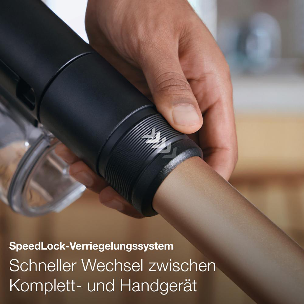 Nahaufnahme eines Staubsaugerteils mit Text über das Verriegelungssystem.