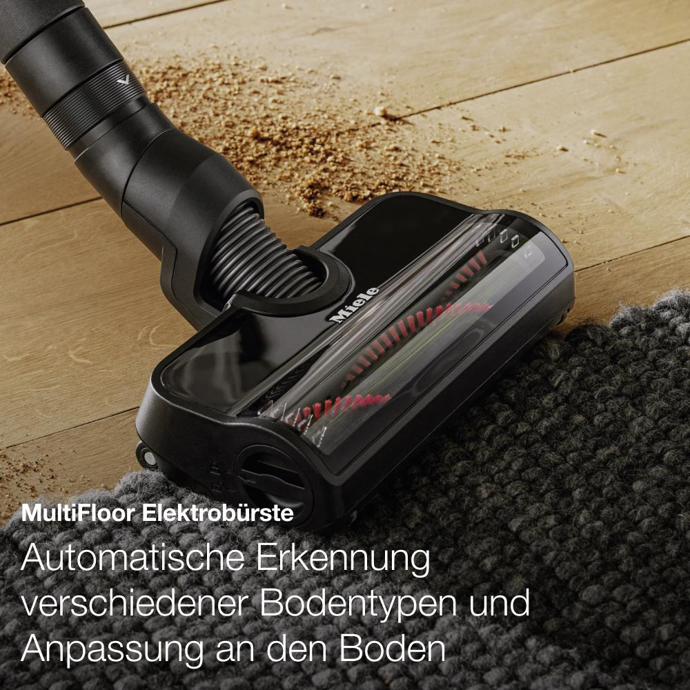 Staubsaugerkopf auf Teppich, auf Holzboden.