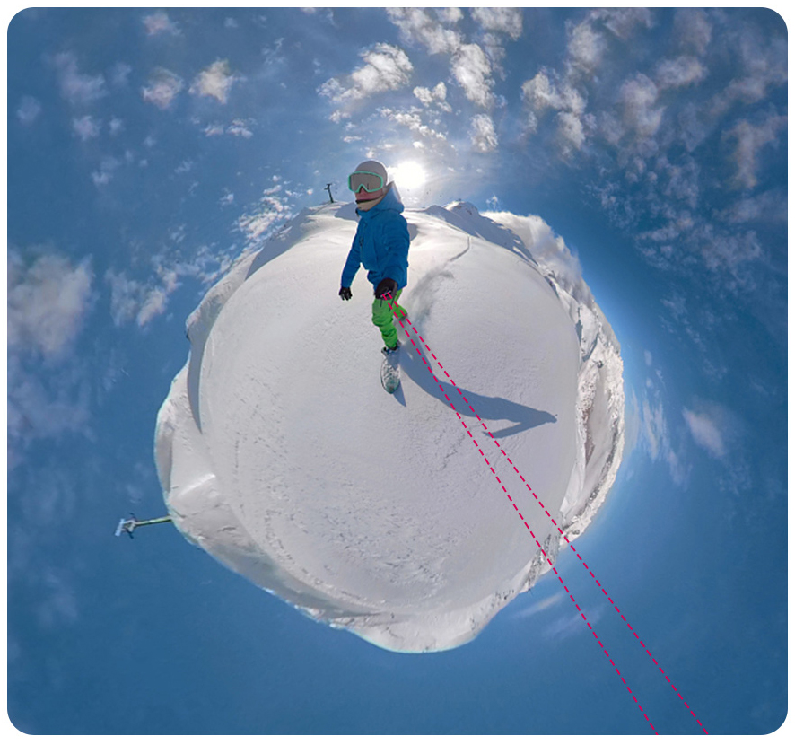 Személy snowboardozik egy hegyen, ragyogó napfény és kék égbolt alatt.