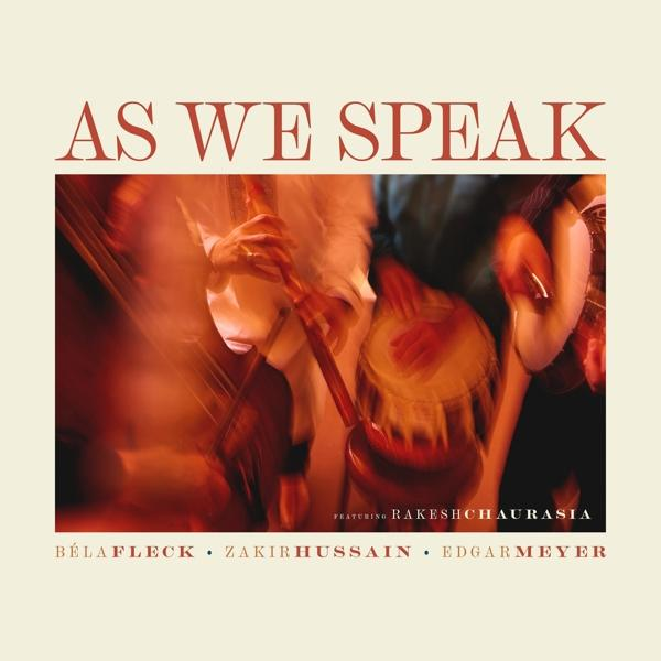 Album borító, a 'As We Speak' szöveggel, három zenész hangszeren játszik.
