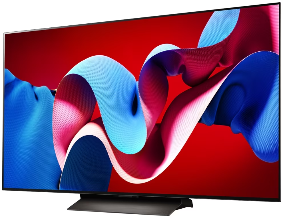 Duży telewizor wyświetla abstrakcyjne, kolorowe kształty na czerwonym tle.