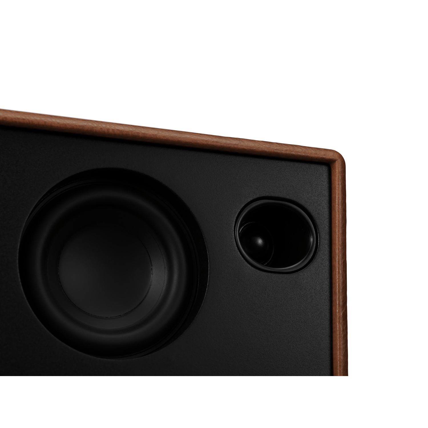 Close-up of a speaker with a black speaker and a brown wood frame.