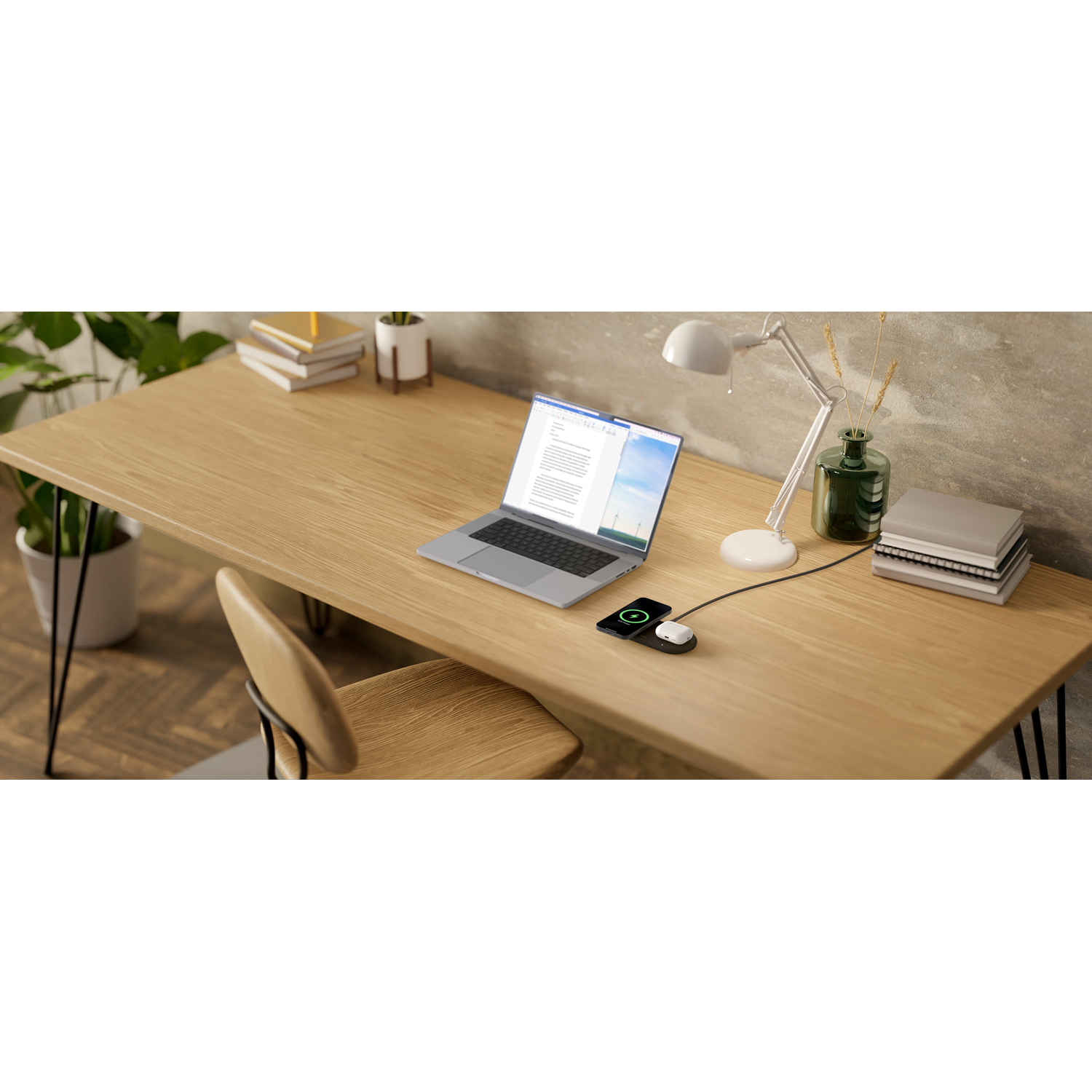 Laptop op een houten bureau met een lamp en een oplaadapparaat. Boeken en een stoel zijn in de buurt.