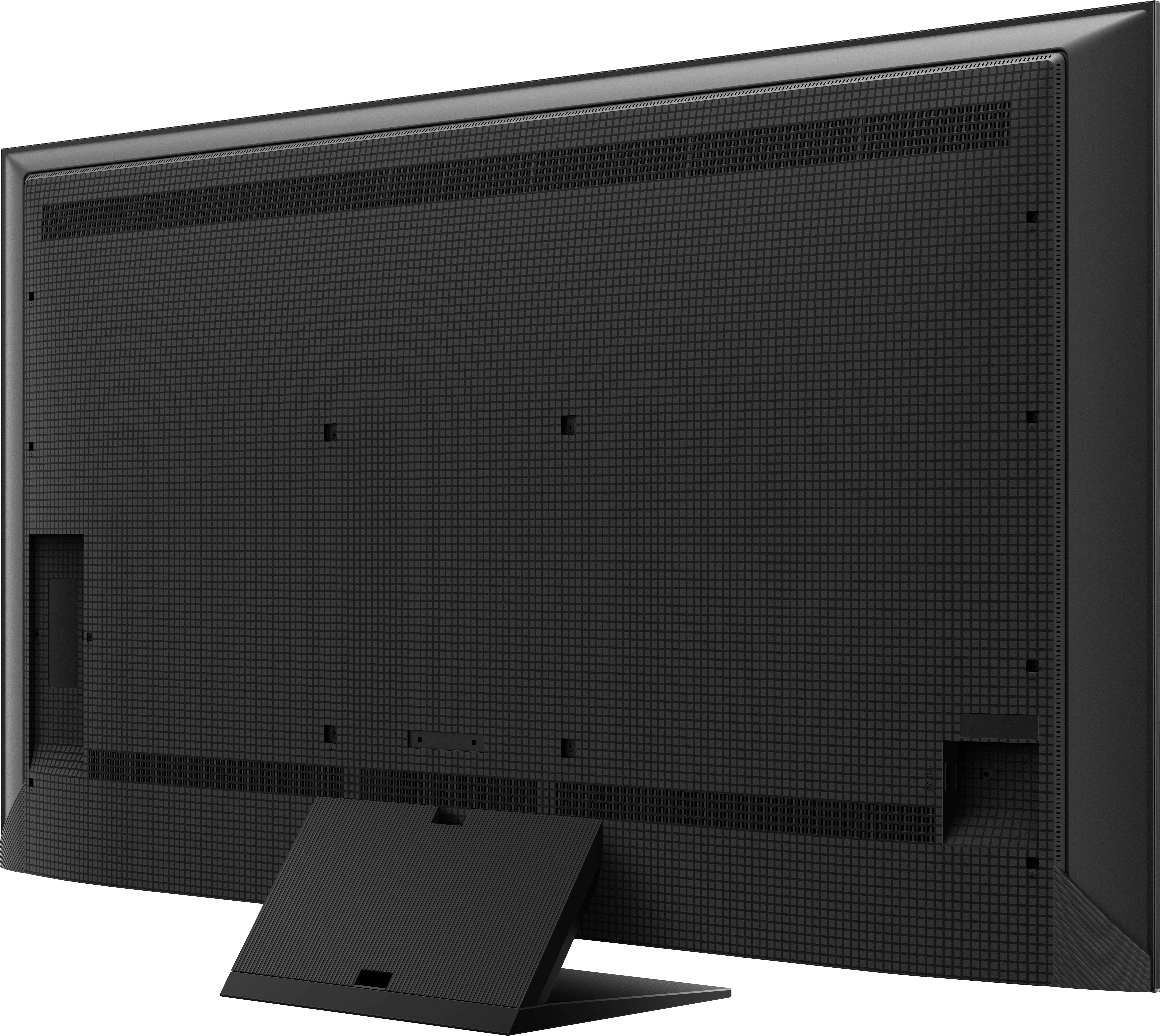Ein schwarzer Laptop, geöffnet, nach links geneigt, mit bunter Tastatur und rotem Hintergrund.