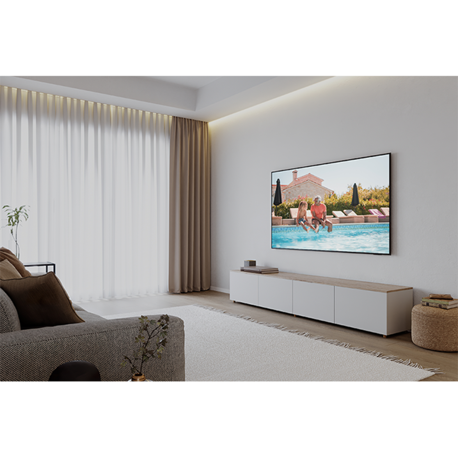 Living room with a TV showing a pool scene. A sofa, rug, curtains, and a side table are visible.