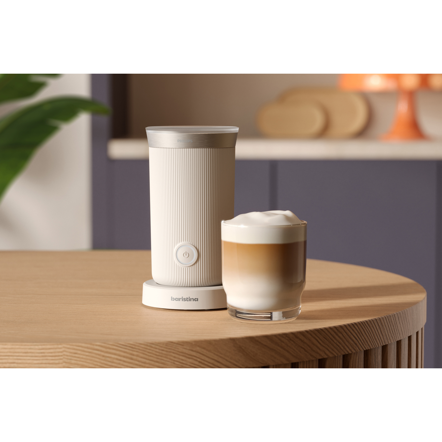 A coffee maker with milk and a coffee cup on a wooden table.