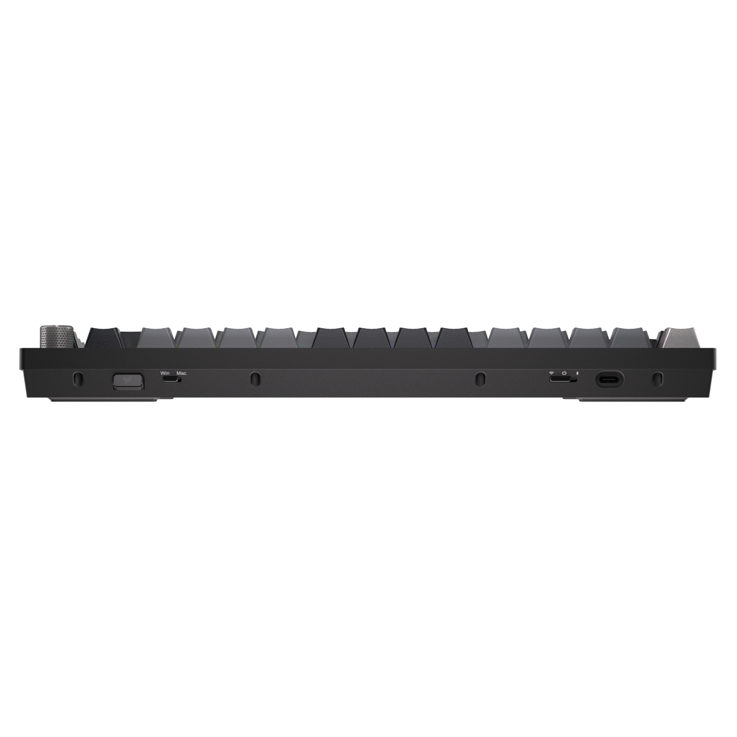 A black keyboard with gray keys is centered against a black background. It has various ports and switches along the sides.
