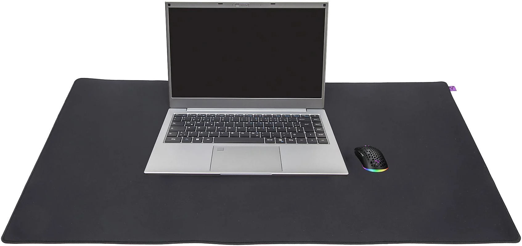 Laptop egy fekete egérpadon egérrel. Fekete háttér.
