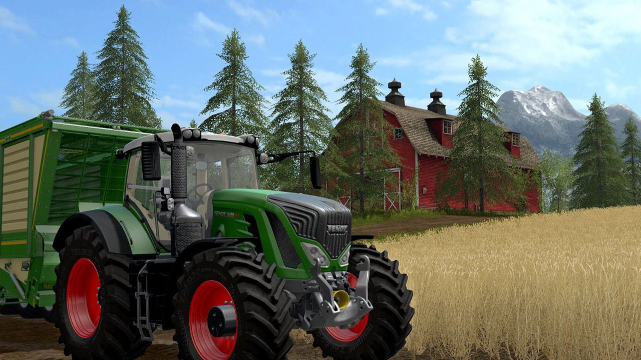 Un tracteur vert avec une remorque dans un champ avec une grange rouge en arrière-plan.