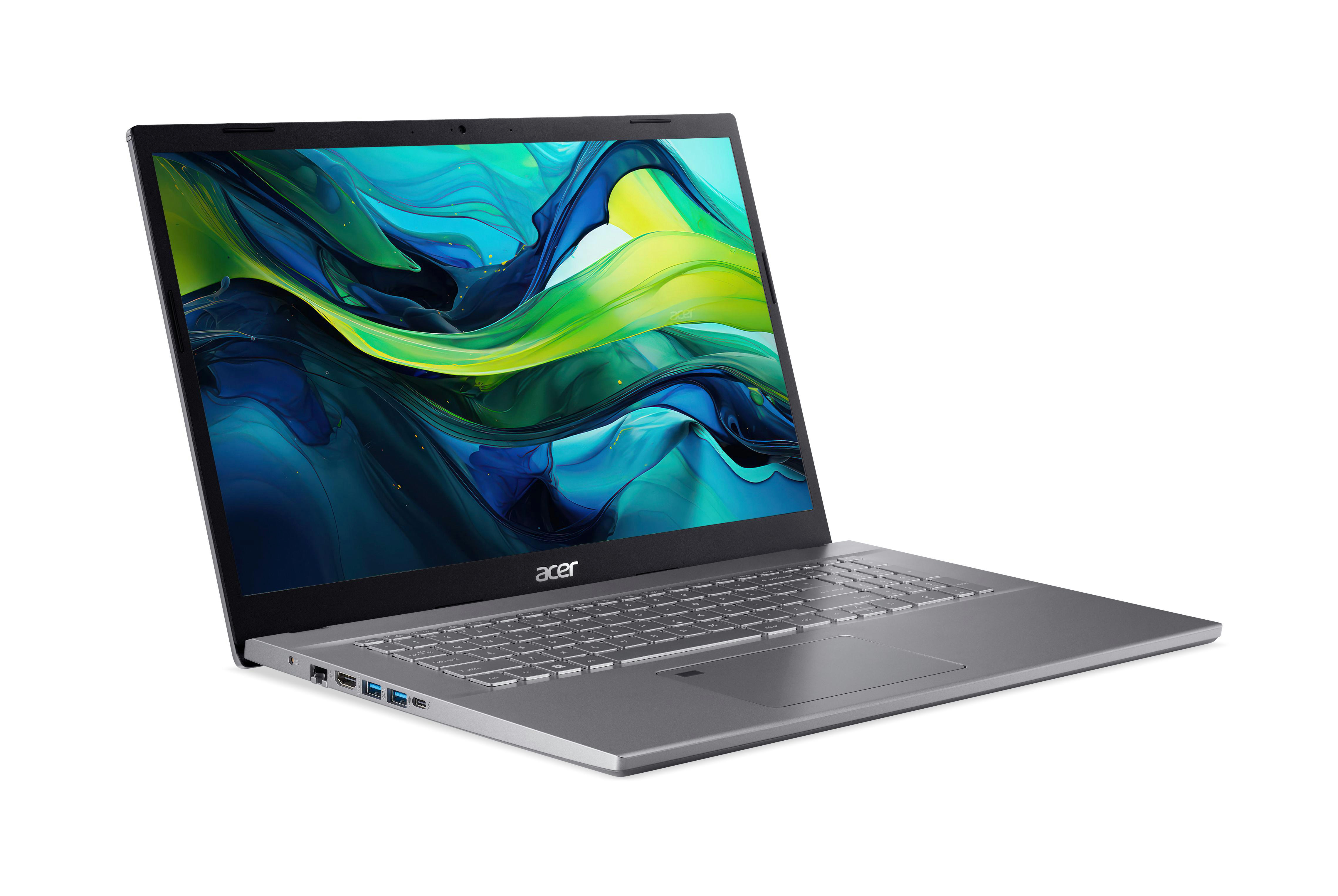 Silberner Laptop offen auf weißer Oberfläche, zeigt farbenfrohes Display.