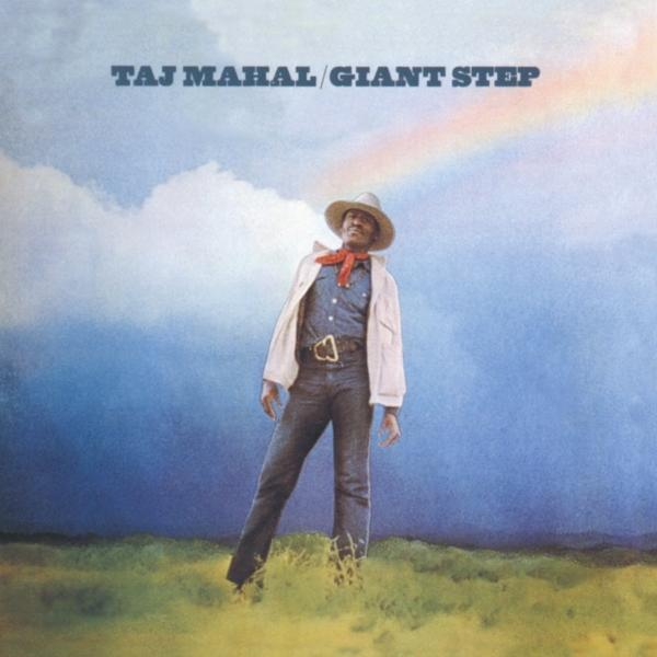 Taj Mahal Albumcover. Ein Mann mit Hut steht auf einem Feld unter einem Regenbogen. Wolkenhimmel im Hintergrund.