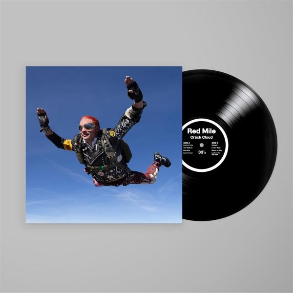 Ein Vinyl-Schallplatten-Albumcover, das einen Fallschirmspringer in der Luft vor blauem Himmel zeigt.