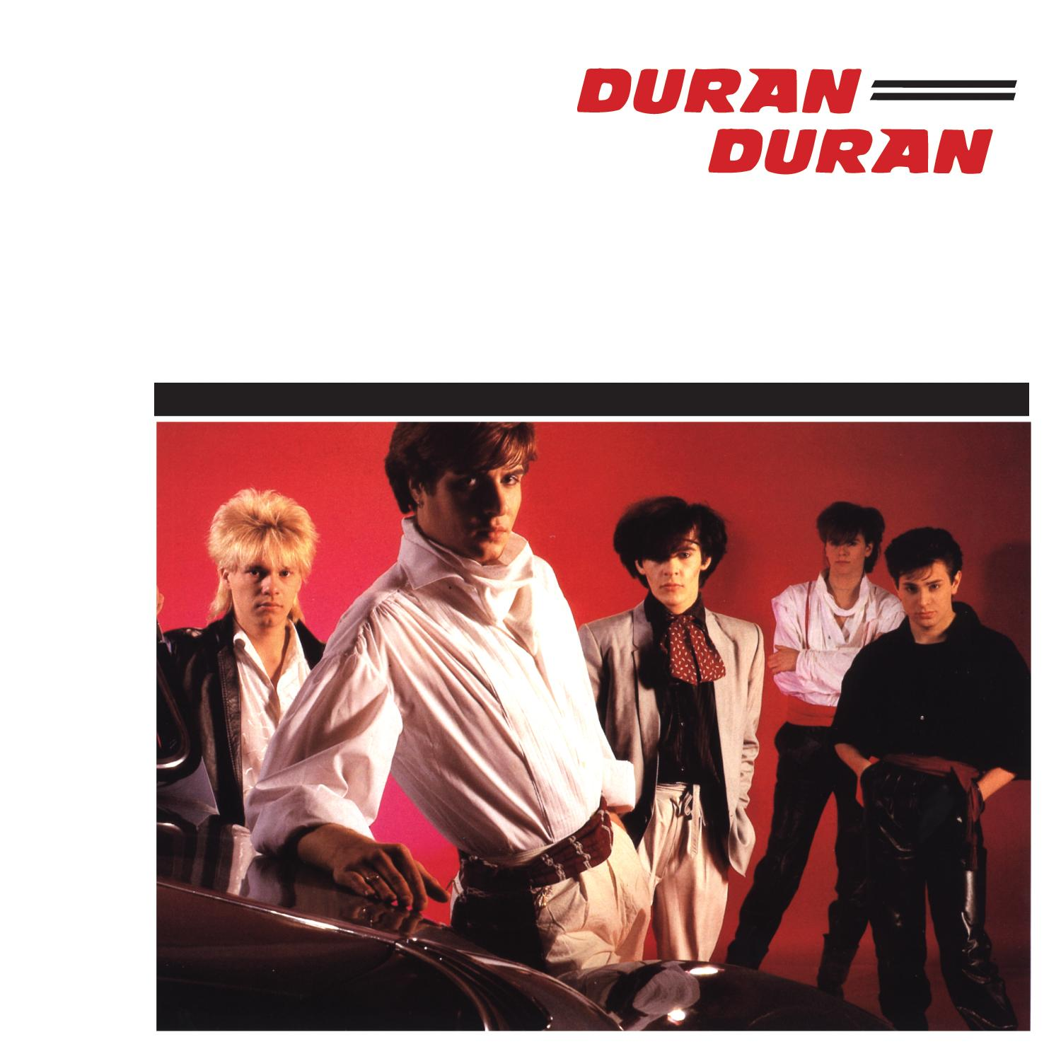 A Duran Duran együttes tagjai egy fotón. A zenekar neve pirossal felül. Piros háttér előtt állnak.