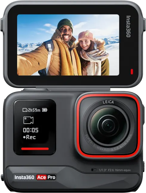 Una fotocamera con uno schermo che mostra un selfie di una coppia in un paesaggio montano innevato.
