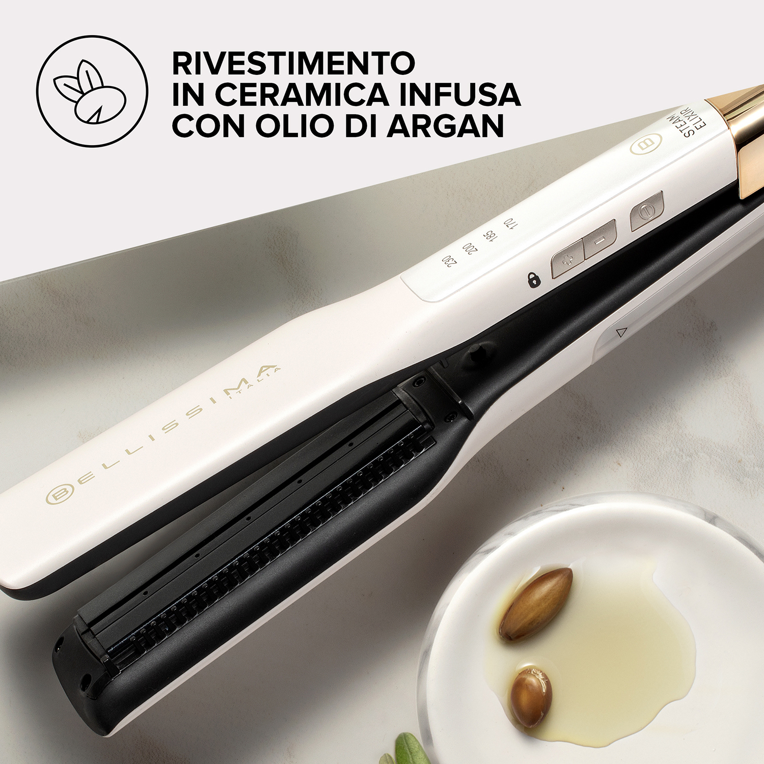 Piastra per capelli, bianca e nera, con olio di argan e semi di argan, su una superficie bianca.