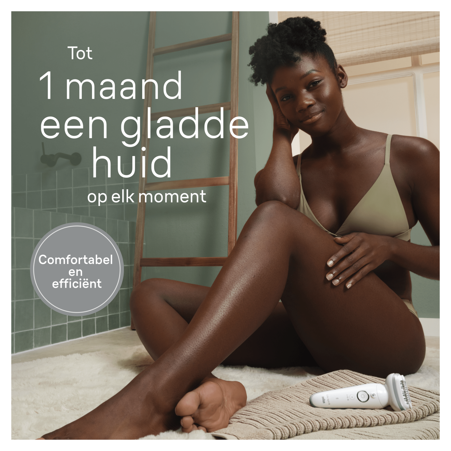 Een vrouw met een gladde huid en een scheerapparaat, zittend op een kleed bij een groene muur.