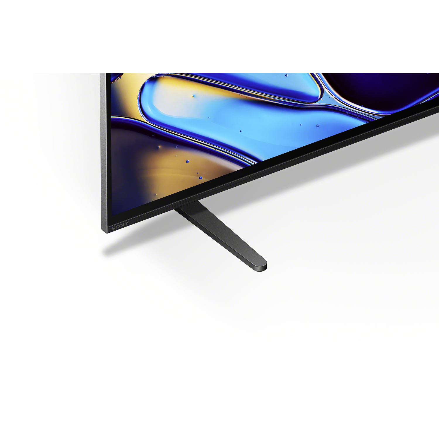 A television's bottom corner, showing a stand and part of the screen. White background.