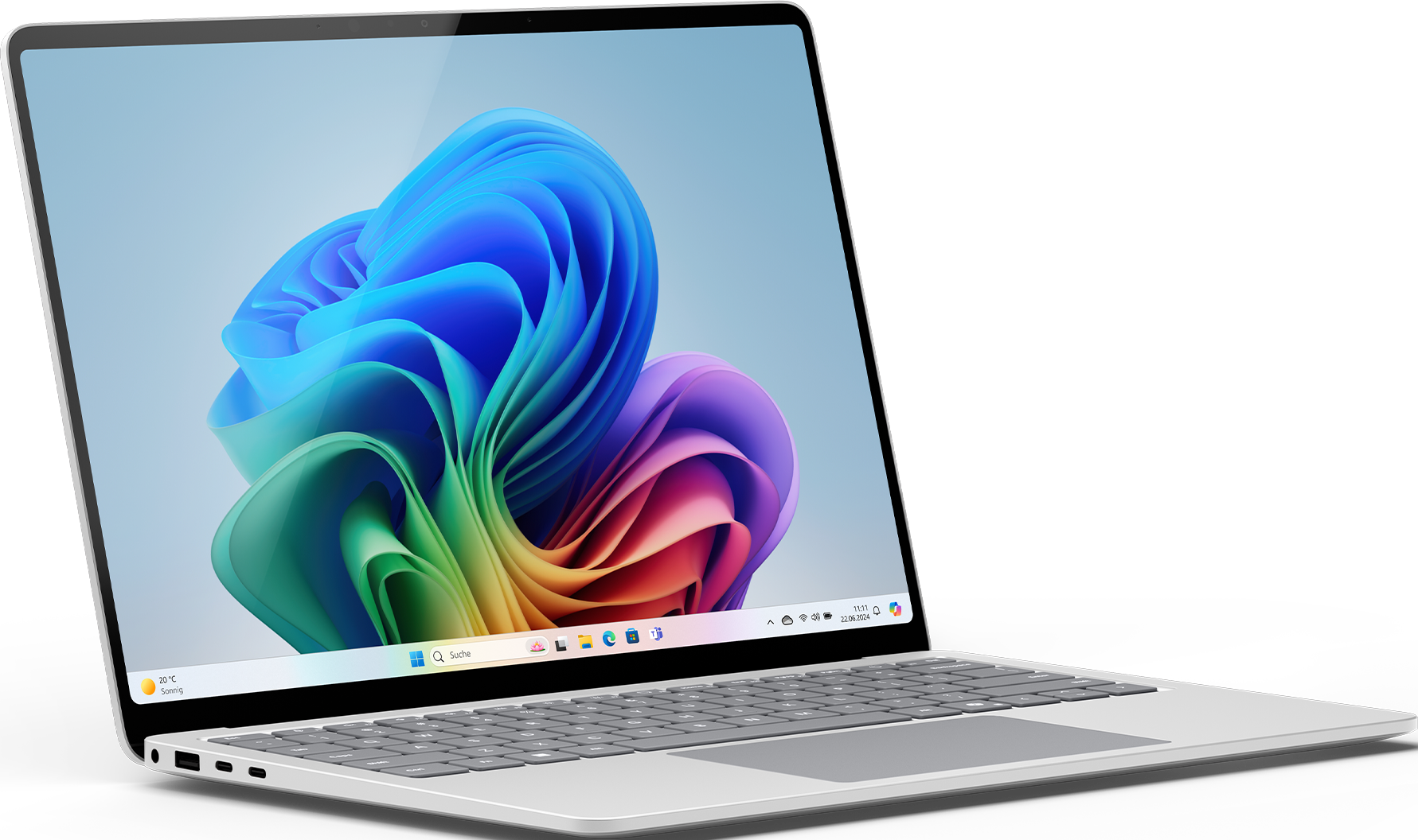 Laptop argentato con display Windows colorato, angolato su una superficie nera.