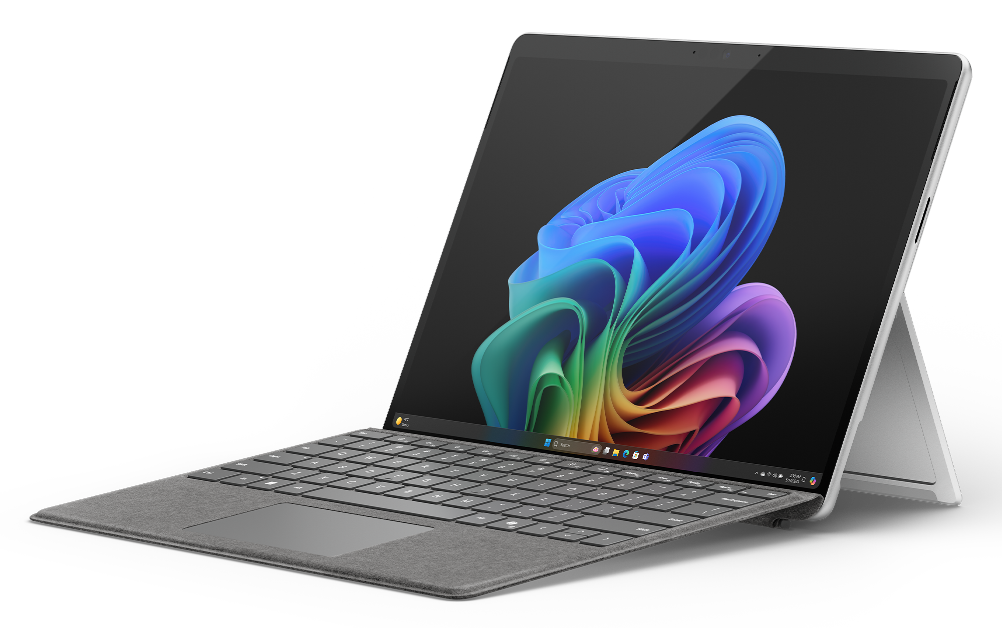 Laptop z otwartym ekranem. Wyświetla kolorowy abstrakcyjny wzór. Klawiatura jest widoczna. Czarne tło.