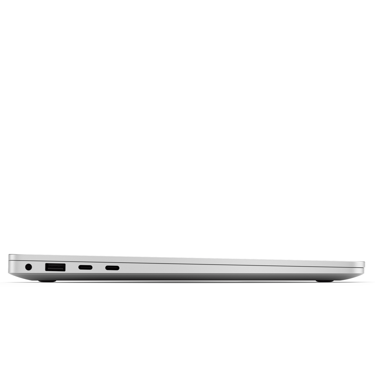 A silver laptop is seen from the side. It has ports and a speaker on the side.