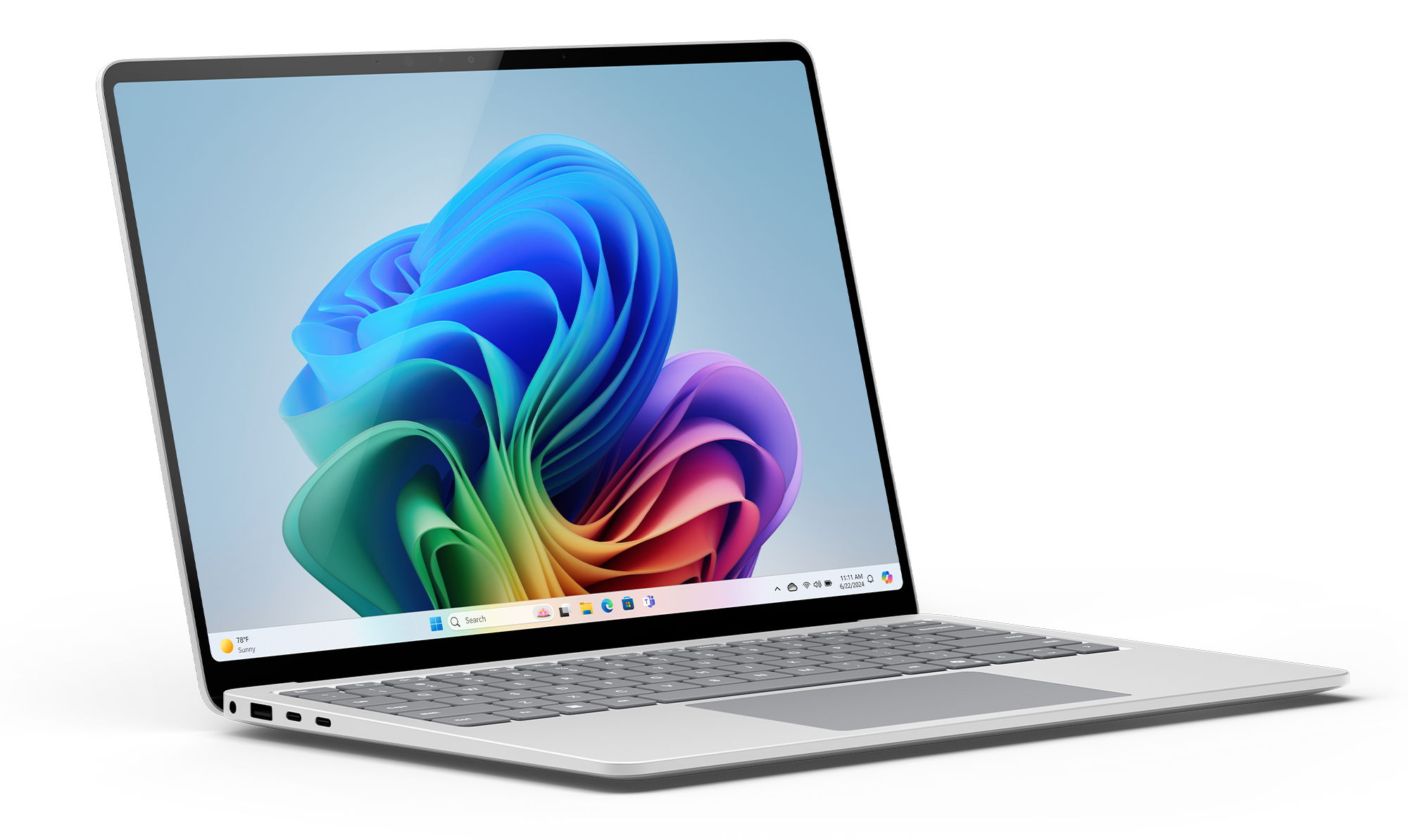 Laptop wyświetla kolorową grafikę na ekranie. Jest otwarty i ustawiony pod kątem. Czarne tło.