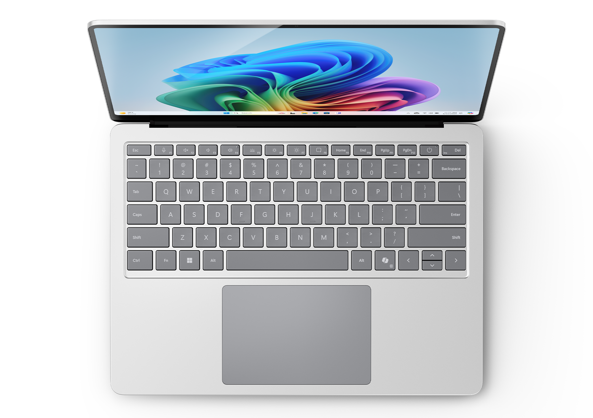 Otwarty laptop pokazuje klawiaturę i kolorowy, abstrakcyjny ekran z góry na czarnym tle.