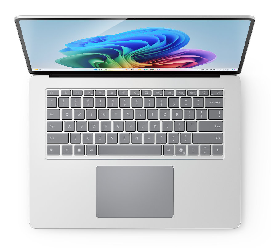 Laptop z góry, pokazujący klawiaturę i ekran z kolorowym wzorem.