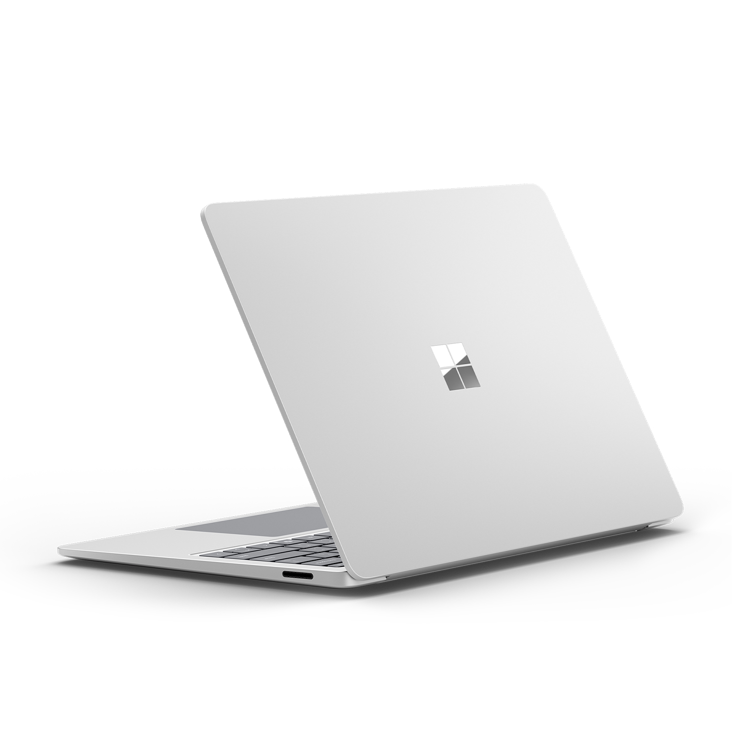 Laptop bianco visto da dietro, con logo Microsoft argentato su superficie bianca.