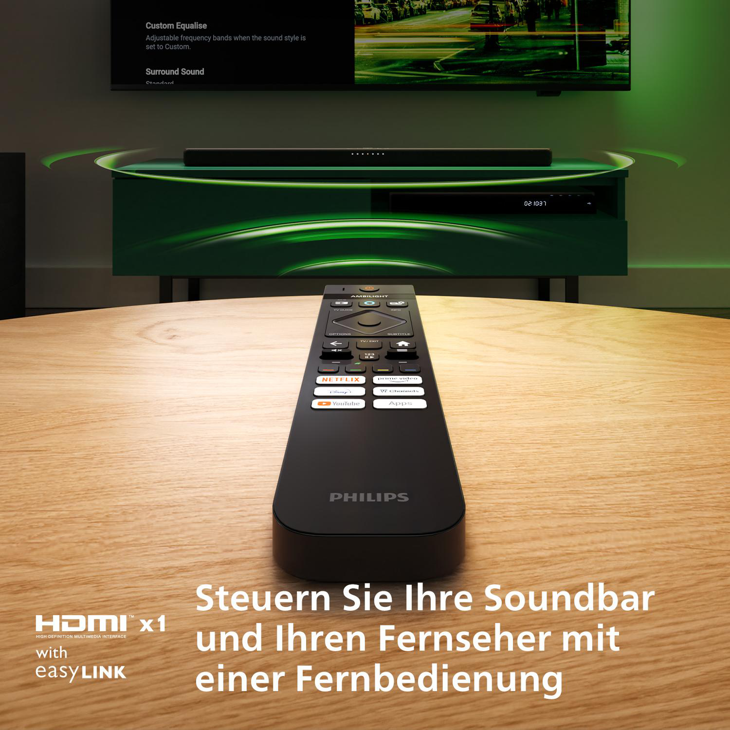 Schwarze Philips-Fernbedienung auf Holztisch. Bildschirm zeigt Soundbar.