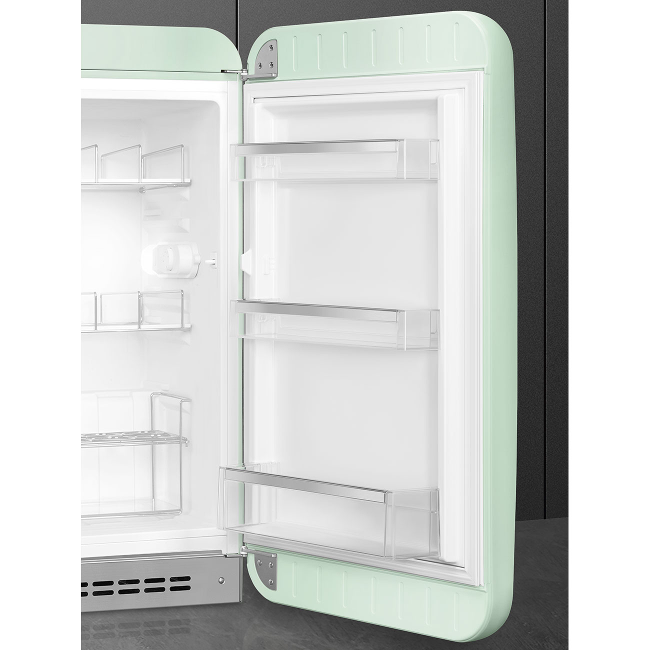 Offener grüner Retro-Kühlschrank innen. Leere Regale sind innen sichtbar.