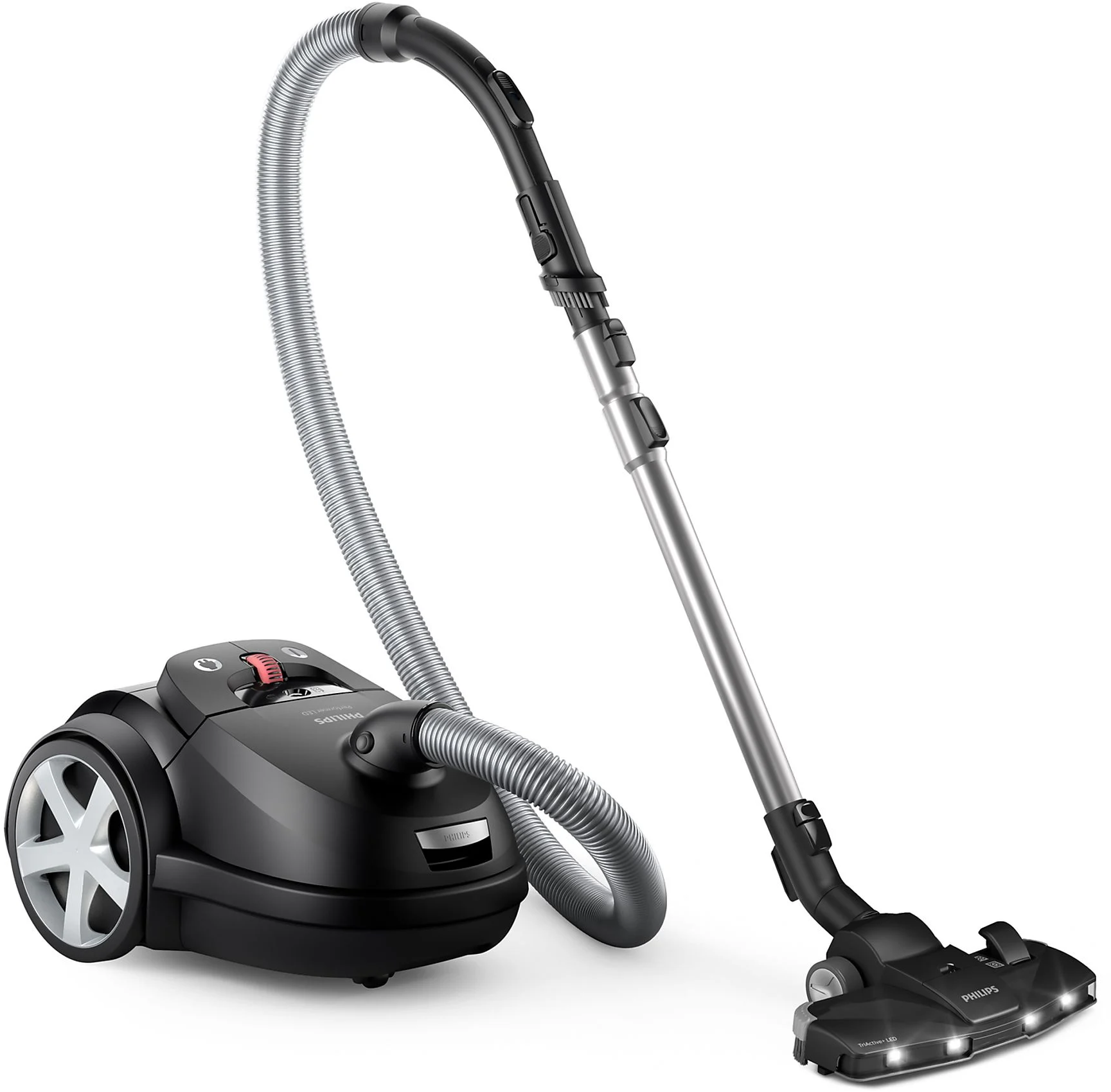 Aspirateur noir, tuyau et tête sur fond blanc. La tête est positionnée à droite.
