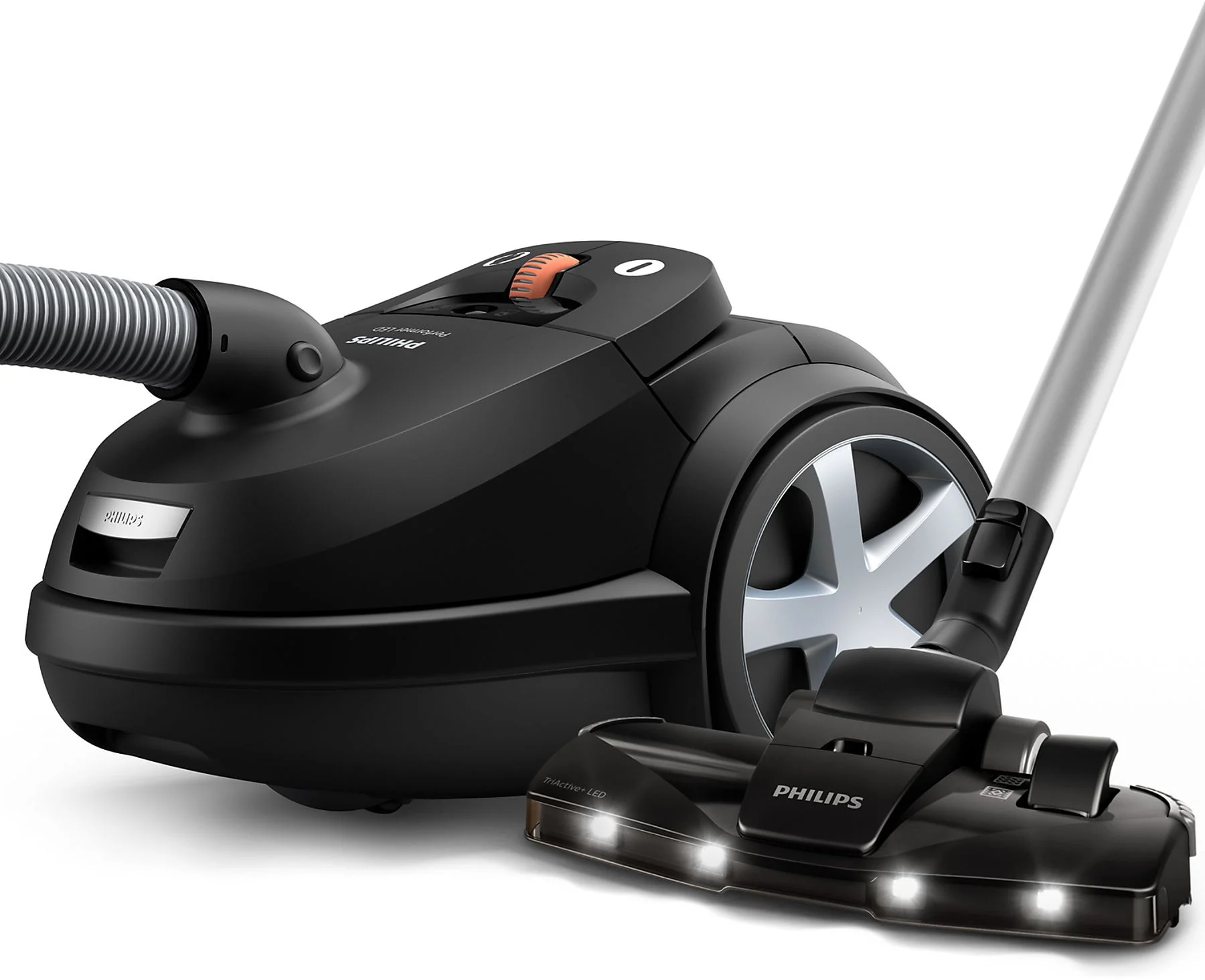 Un aspirateur noir avec un tuyau noir et argenté.