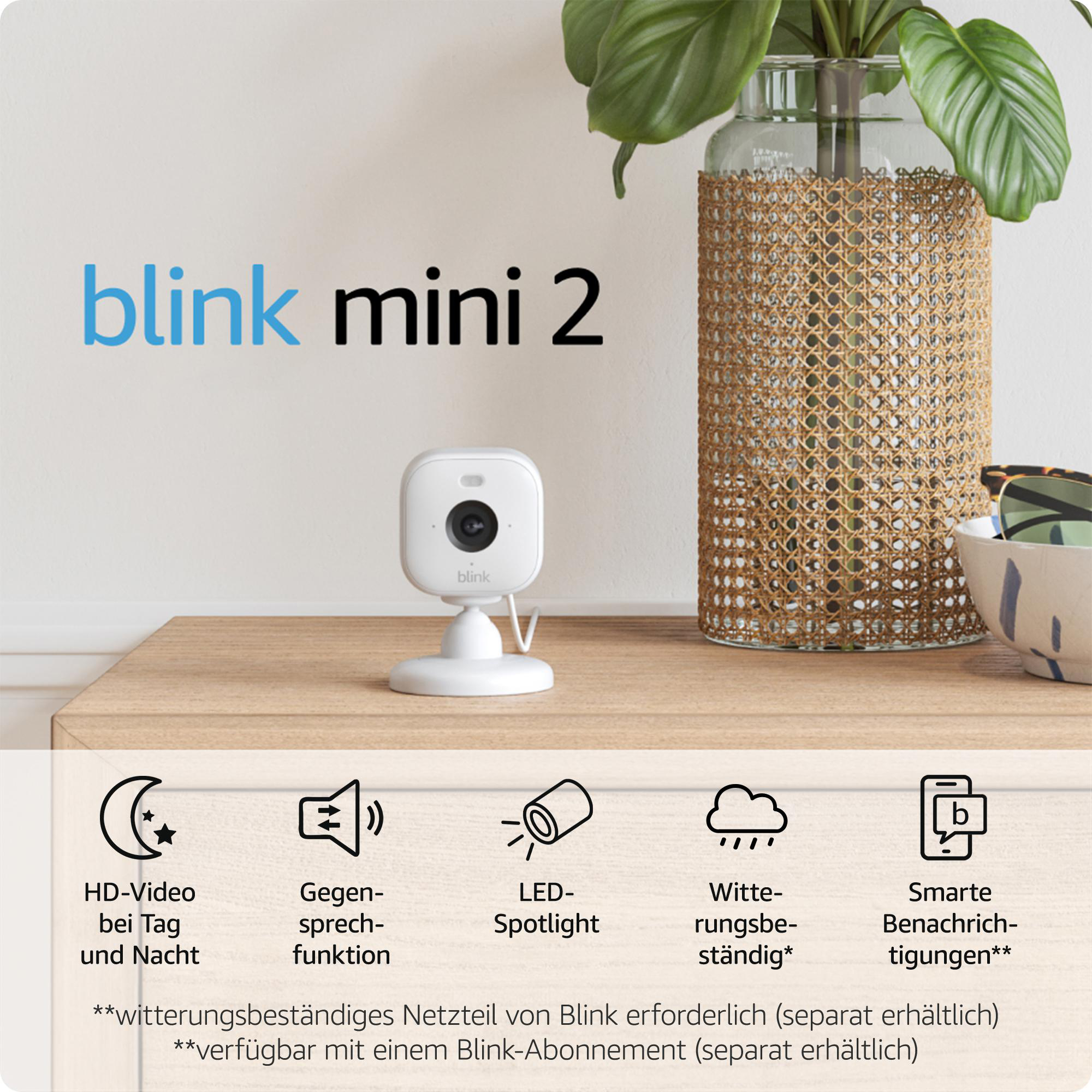 Weiße Blink Mini 2 Kamera auf Holzoberfläche.