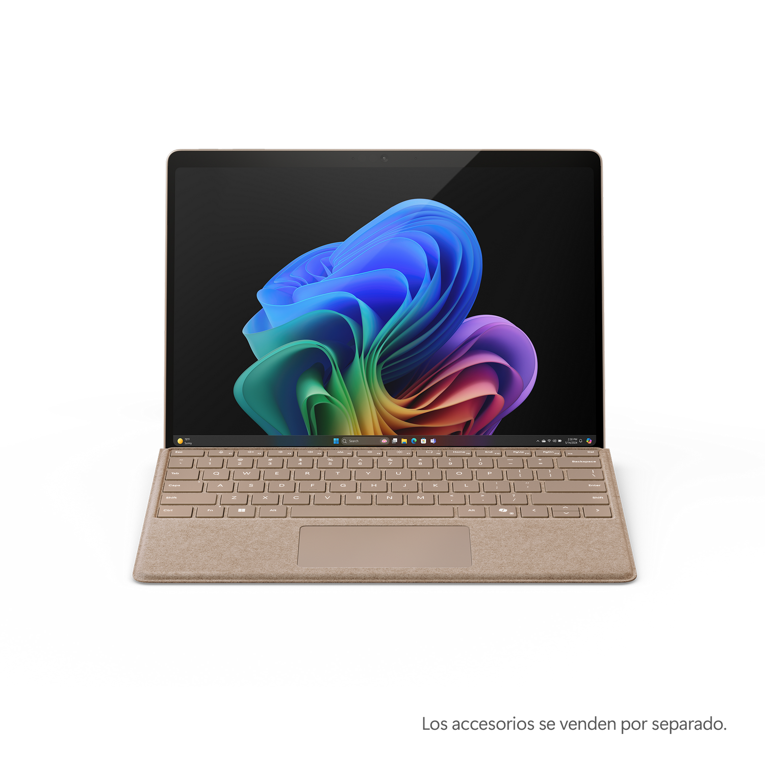 Laptop dorado con teclado muestra imagen abstracta colorida sobre superficie negra.