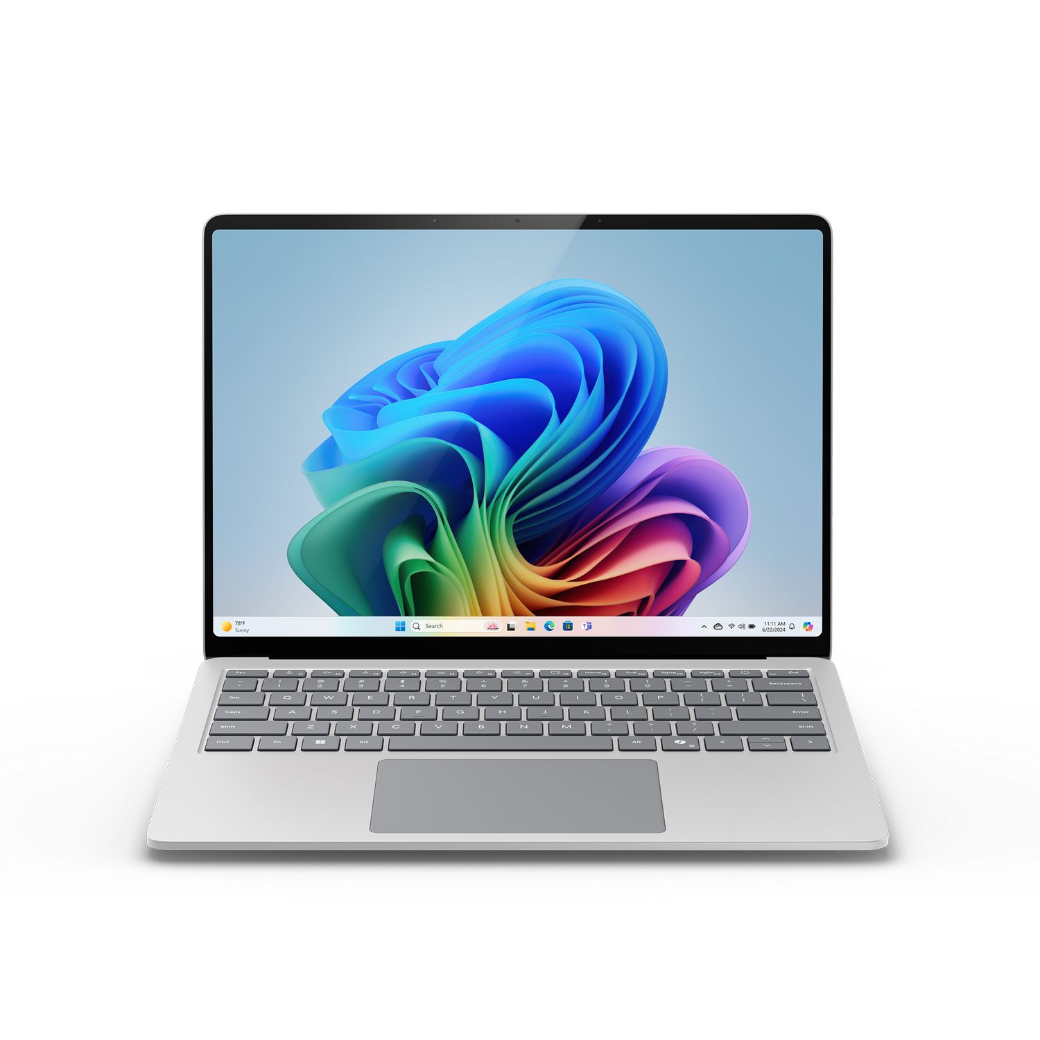 Laptop en superficie gris. Pantalla muestra fondo de pantalla colorido.