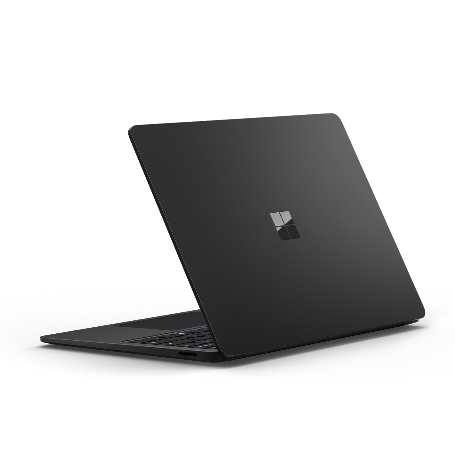 Una computadora portátil negra sobre un fondo oscuro, inclinada para mostrar la parte trasera.