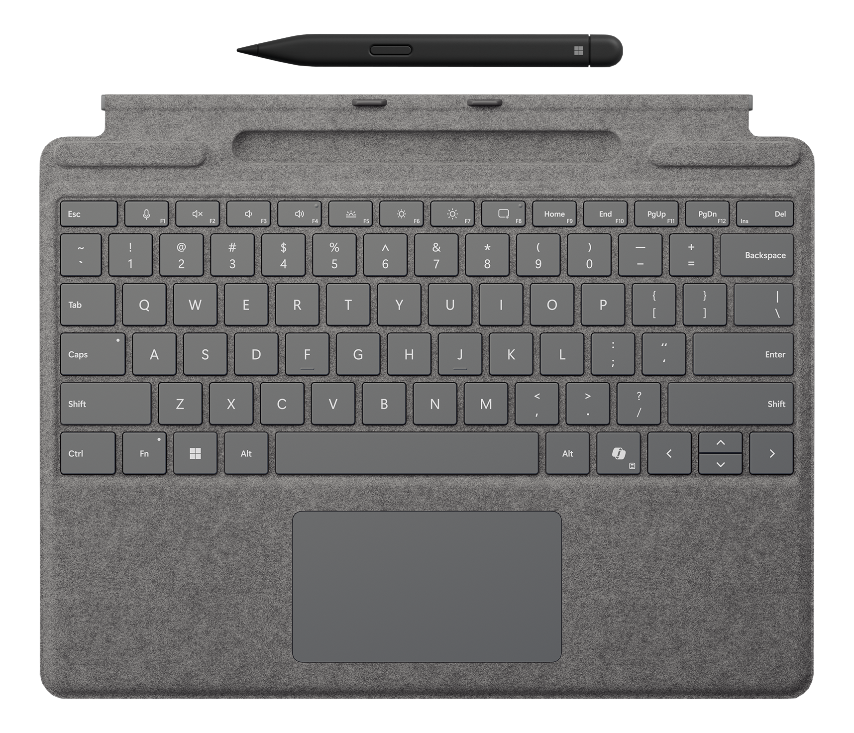 Un clavier gris avec un trackpad et un stylet noir dessus. Le clavier a une surface gris foncé.