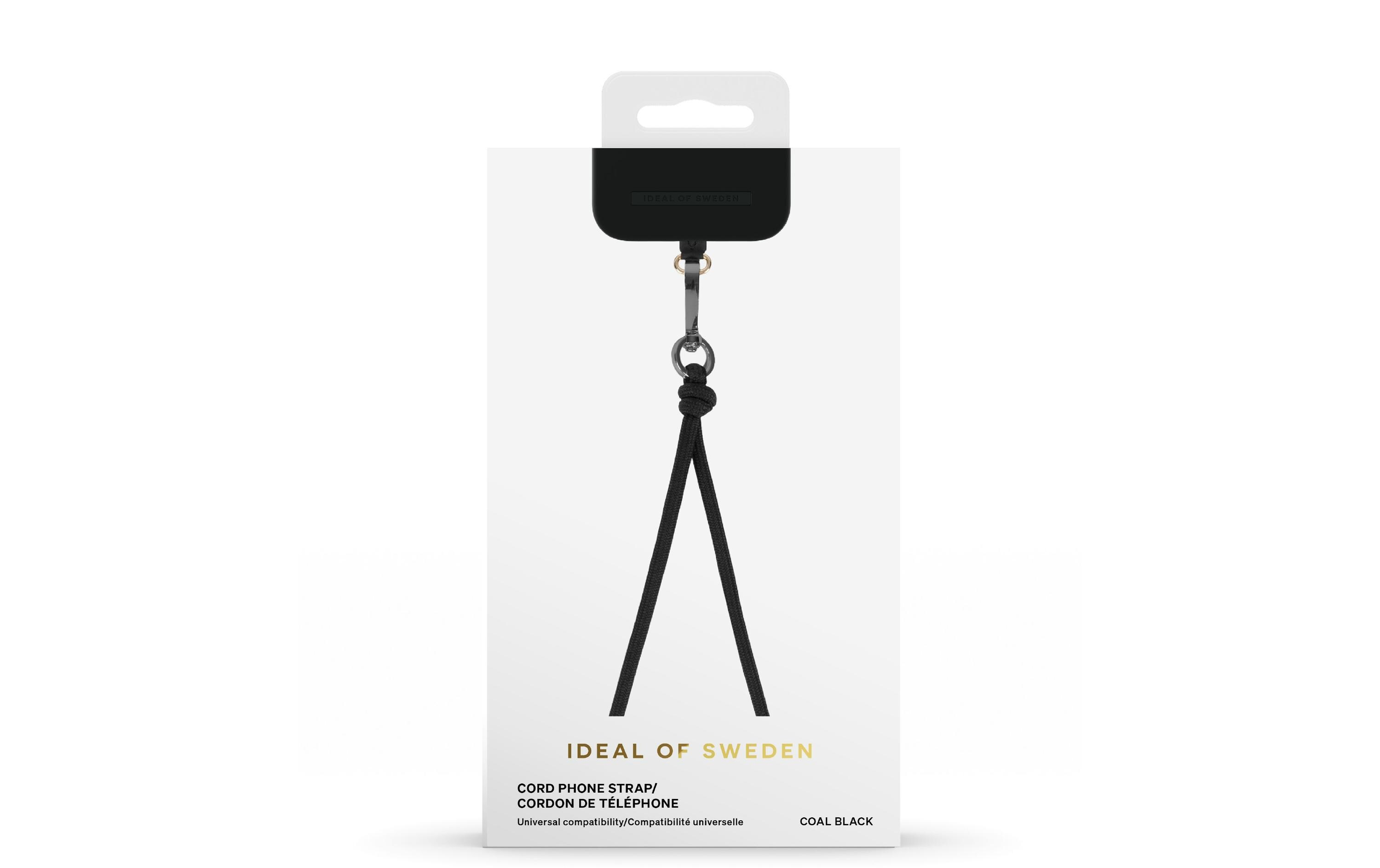 Un cinturino nero per telefono in una confezione bianca. Il cinturino è appeso. La confezione ha il testo: IDEAL OF SWEDEN, COAL BLACK.