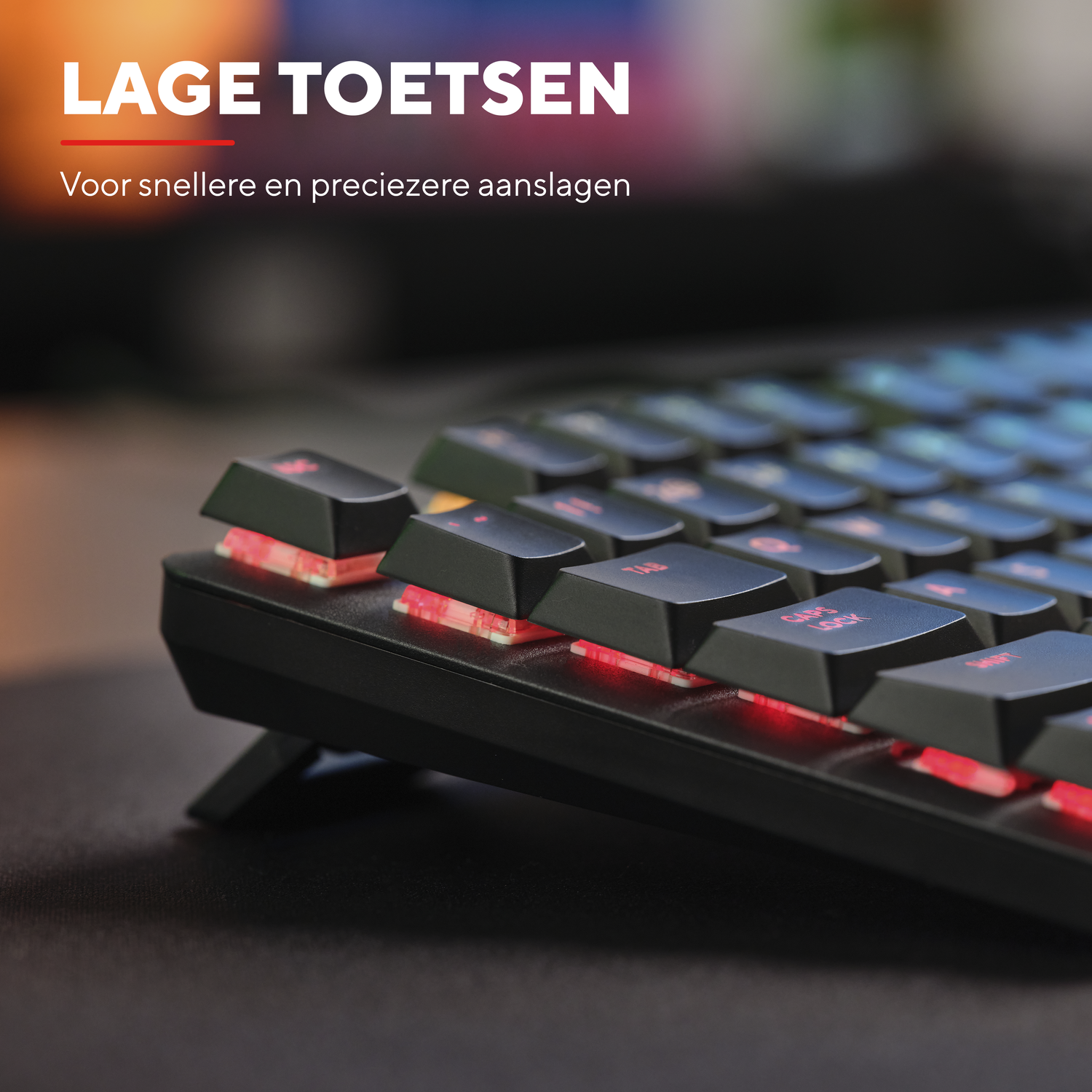 A close-up of a black keyboard with lit red keys. Text above reads: LOW KEYS.