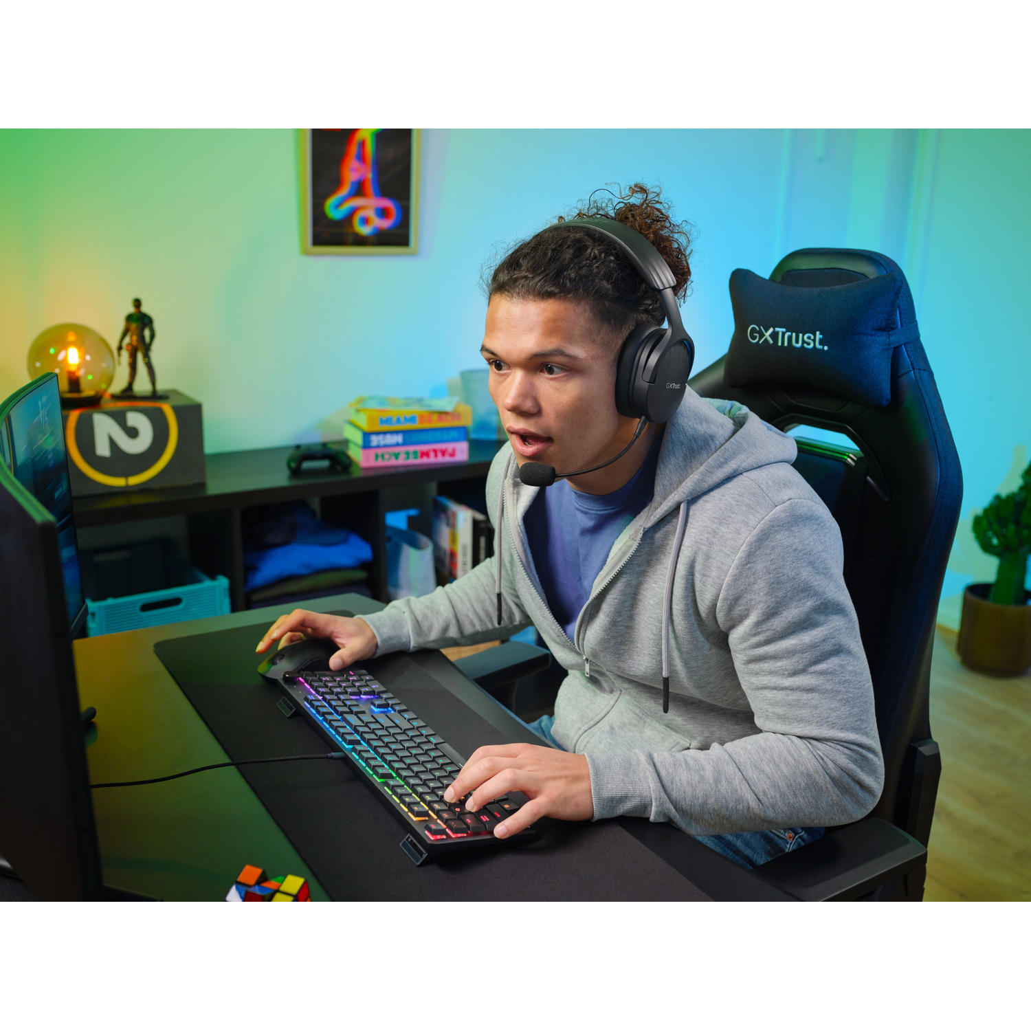 A person wearing a headset and using a computer. They are looking at the screen with an open mouth.