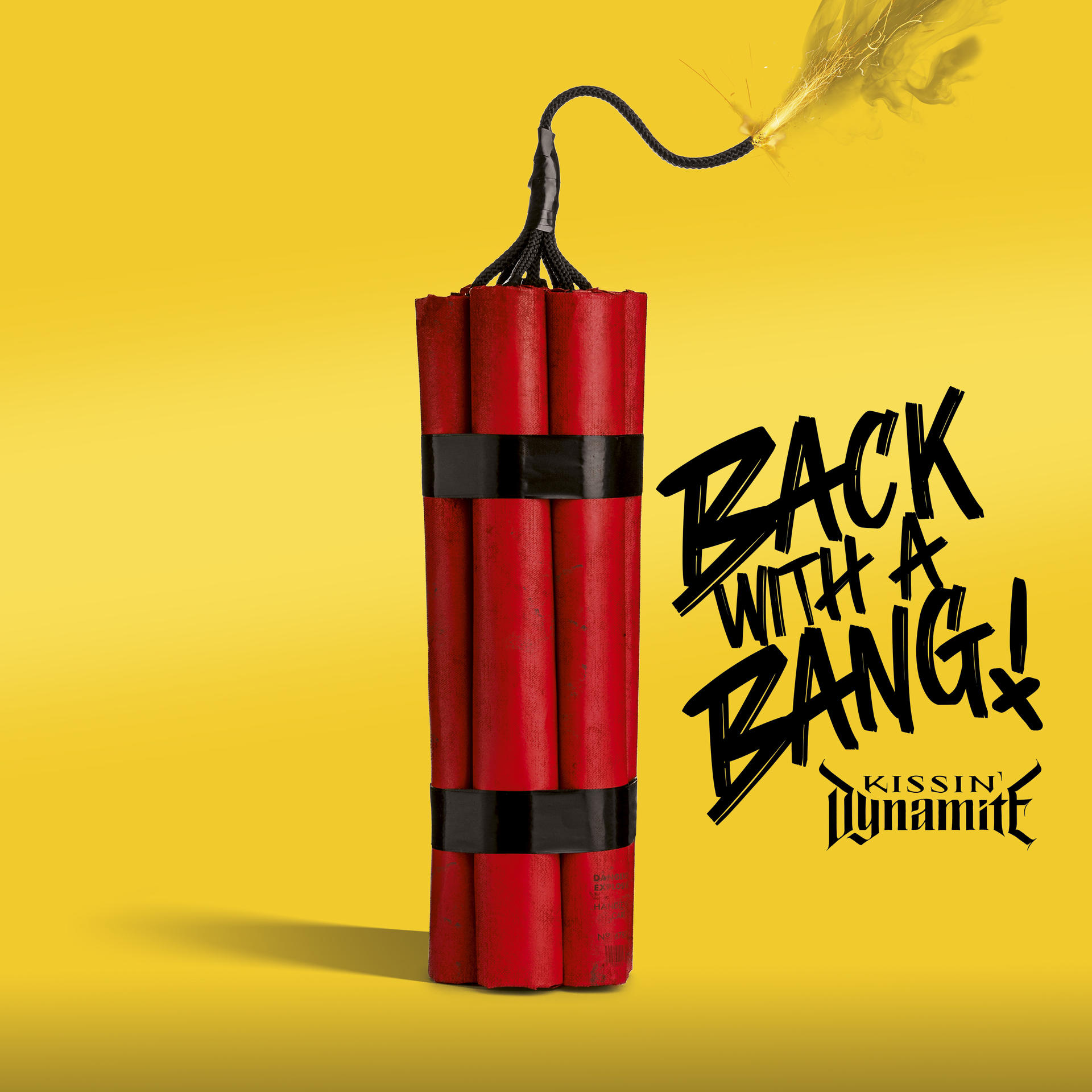 Dinamitcsomag égő kanóccal és a 'BACK WITH A BANG!' felirattal sárga háttéren.