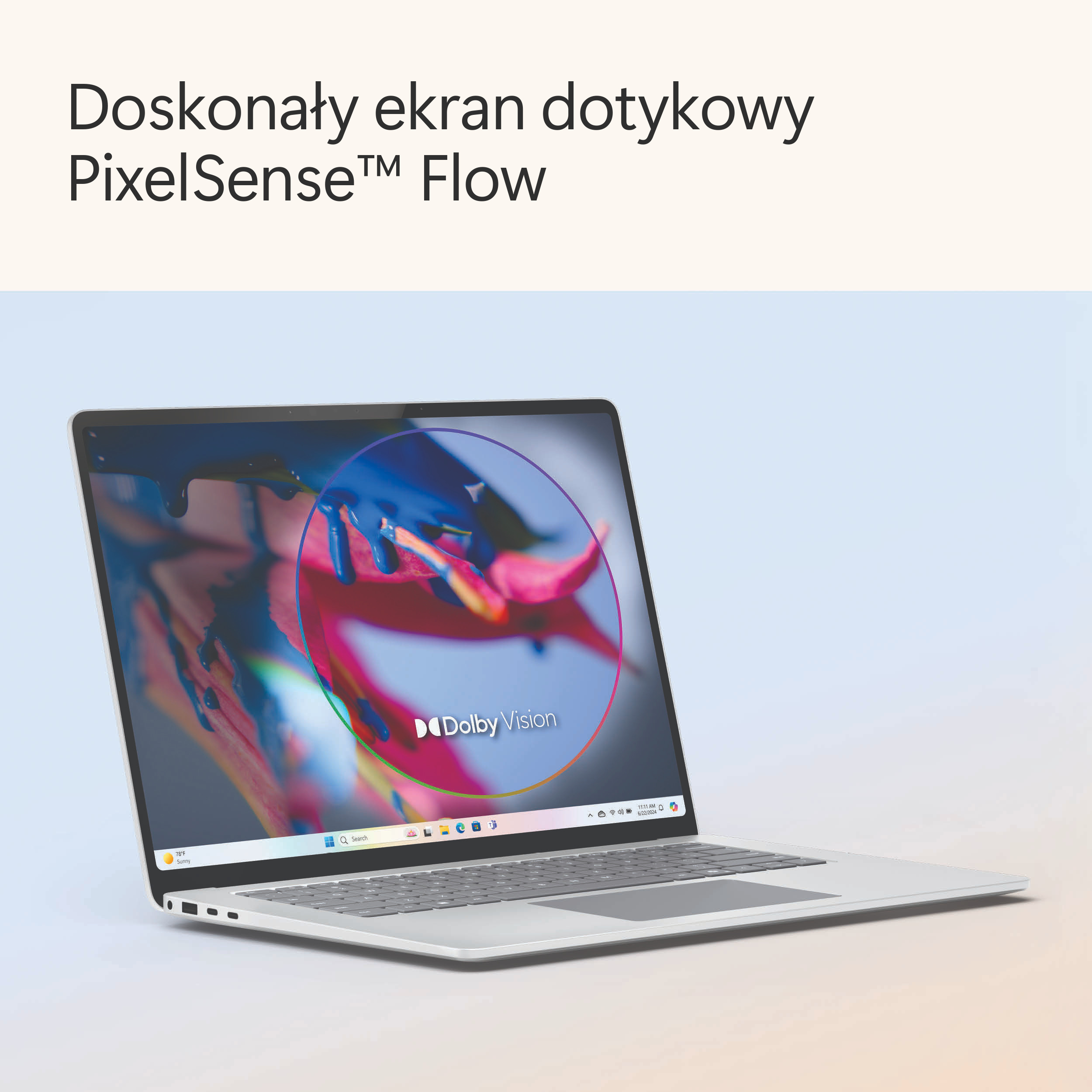 Otwarty srebrny laptop, wyświetlający kolorowy ekran powitalny na ekranie.